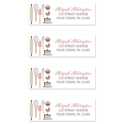 Pink Baking Address Labels at Artistically Invited. Image shows 4 labels. High-quality address labels designed with cute kitchen baking tools and baked treats in pink, brown, gray, and beige on the left side over a white background. Your personalized return address is custom printed in pink and brown to the right of the pink baking tools and baked goods design. These premium return address labels are great for bakers, pastry chefs, or anyone who loves baking.