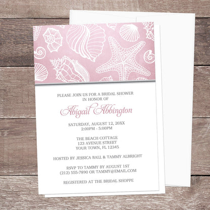 Pink Beach Seashell Pattern Bridal Shower Invitation shown on a wooden surface with a white envelope.