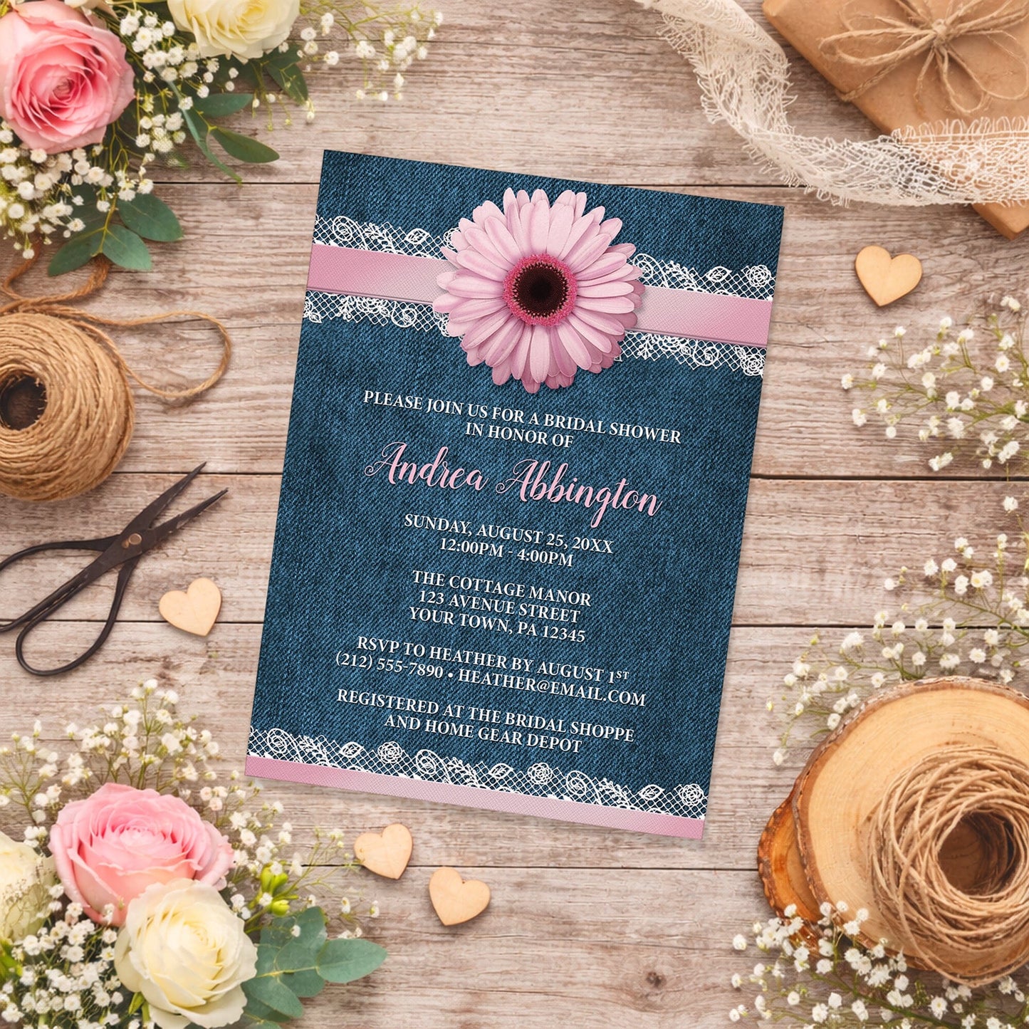 Pink Daisy Lace Rustic Denim Bridal Shower Invitation on a rustic wood surface with spring and summer flowers and twine.