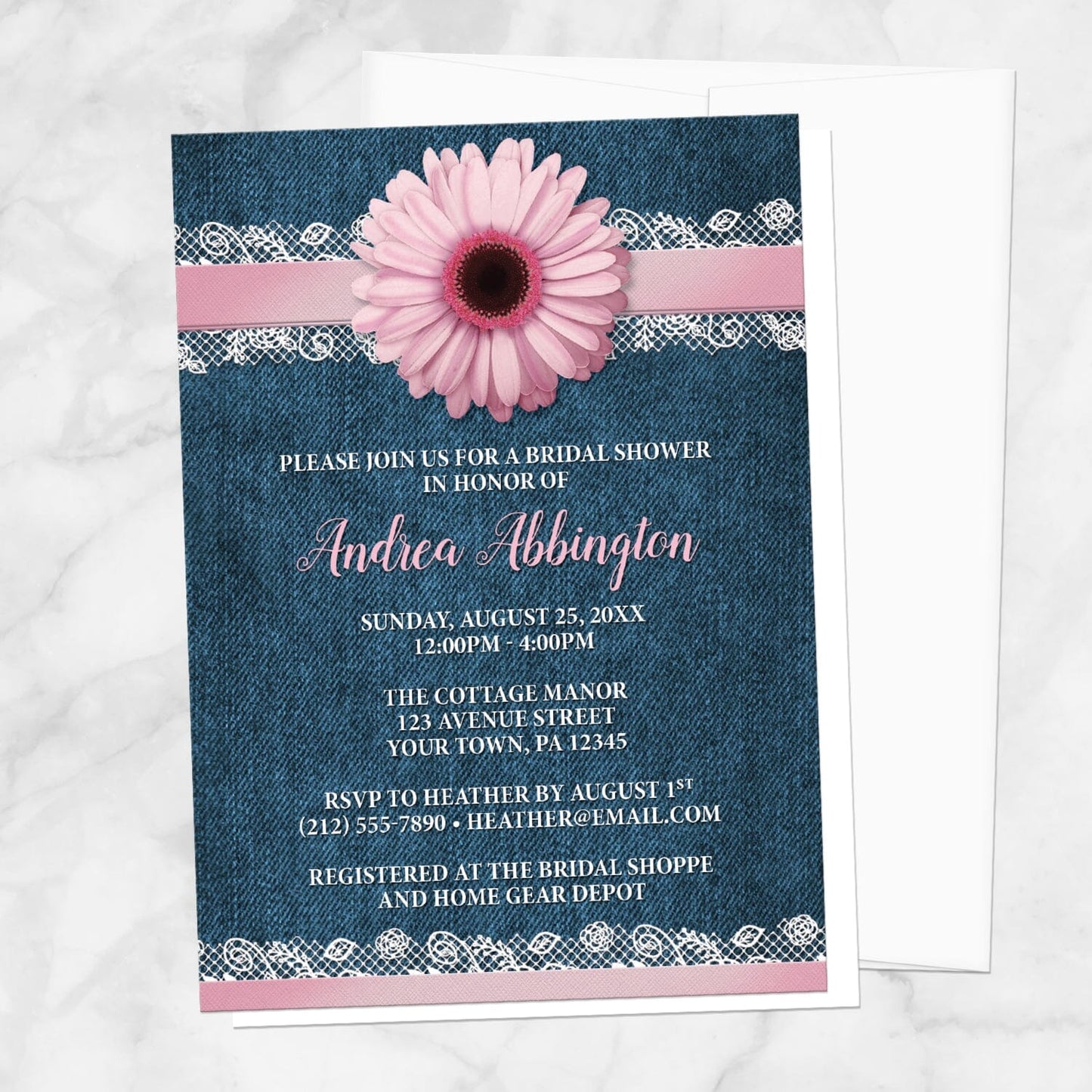 Bridal shower invitation with a pink daisy, denim and lace, displayed with a white envelope on a marble surface