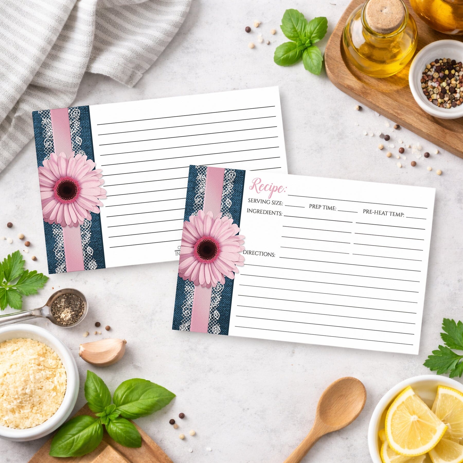 Set of Pink Daisy Lace Rustic Denim Recipe Cards on a kitchen counter with ingredients.