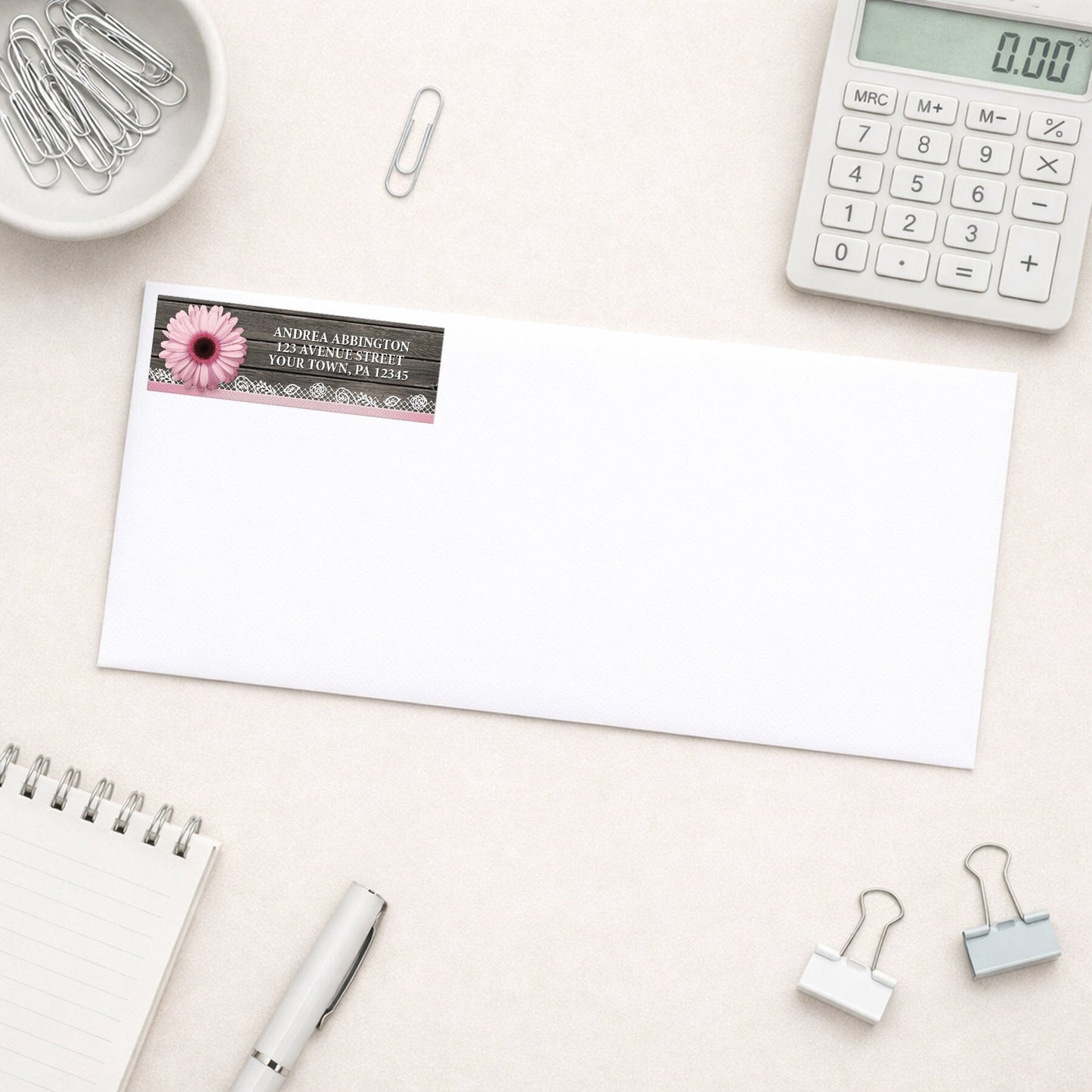 Pink Daisy Lace Rustic Wood Address Label shown on a white envelope with everyday office supplies