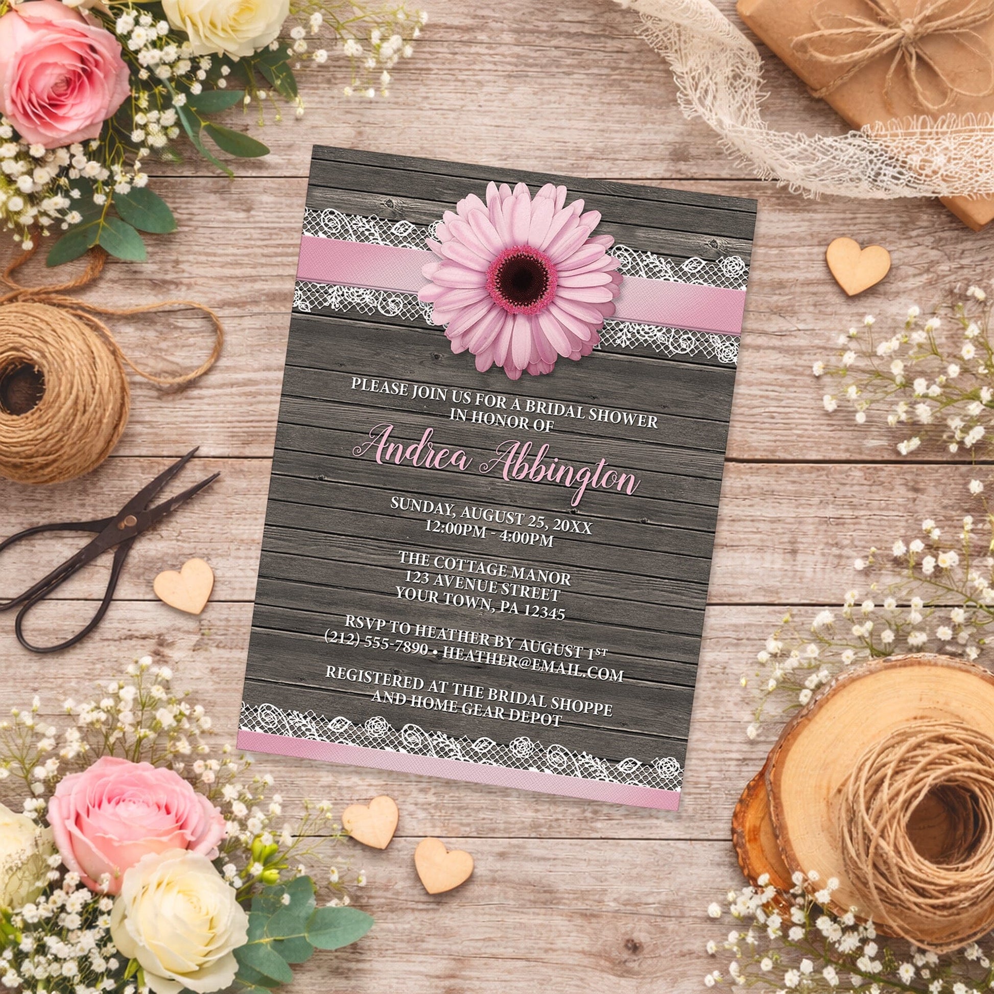 Pink Daisy Lace Rustic Wood Bridal Shower Invitation shown on a wooden surface with spring and summer flowers, wooden hearts, and twine.