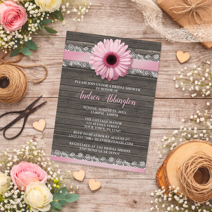 Pink Daisy Lace Rustic Wood Bridal Shower Invitation shown on a wooden surface with spring and summer flowers, wooden hearts, and twine.