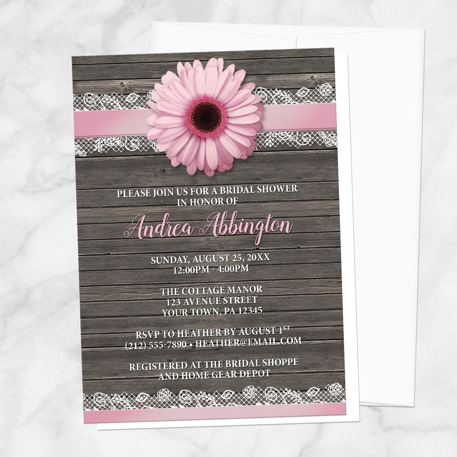 Pink Daisy Lace Rustic Wood Bridal Shower Invitation shown on a marble surface with a white envelope.