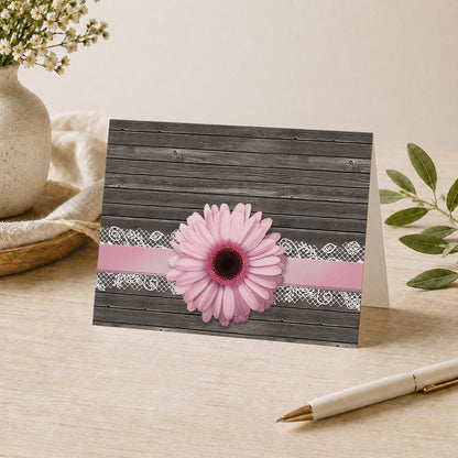Pink Daisy Lace Rustic Wood Note Card shown on a desk with a vase, plants, and a pen.