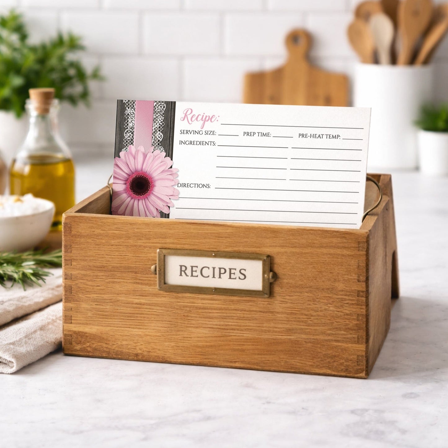 Wooden recipe box with a Pink Daisy Lace Rustic Wood Recipe Card on top, shown on a kitchen counter