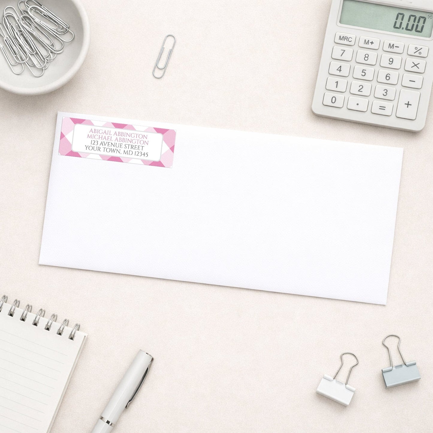 Pink Gingham Address Label shown on a white envelope with everyday office supplies