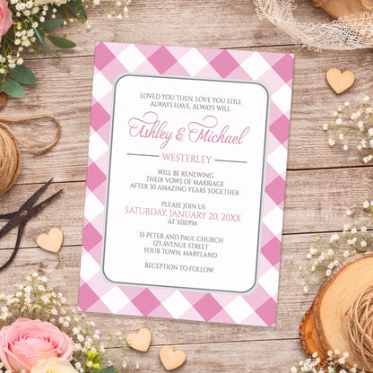 Pink Gingham Vow Renewal Invitation shown on a wooden surface with spring and summer flowers, small wood hearts, lace, and twine.