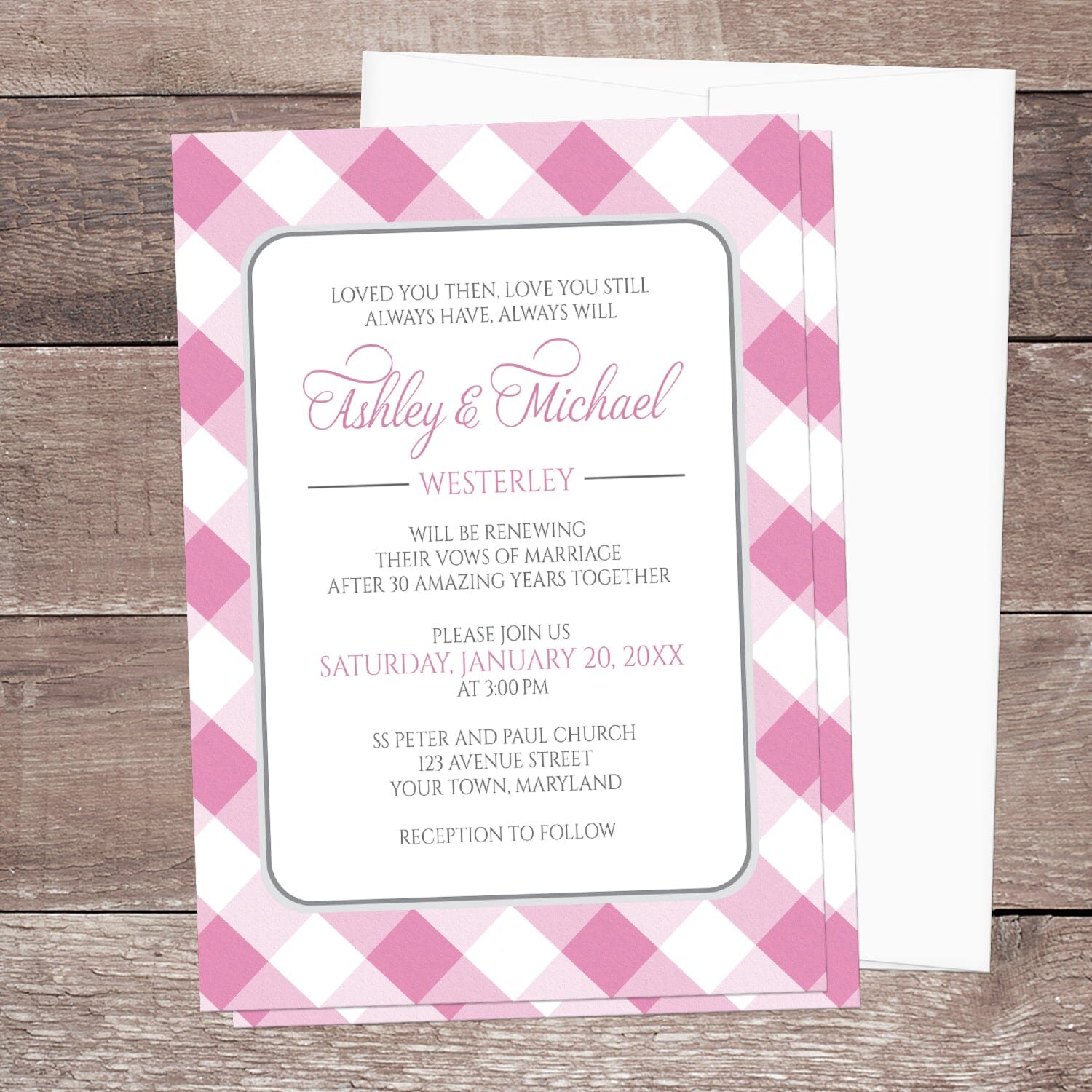 Pink Gingham Vow Renewal Invitation shown on a brown wood surface with a white envelope.