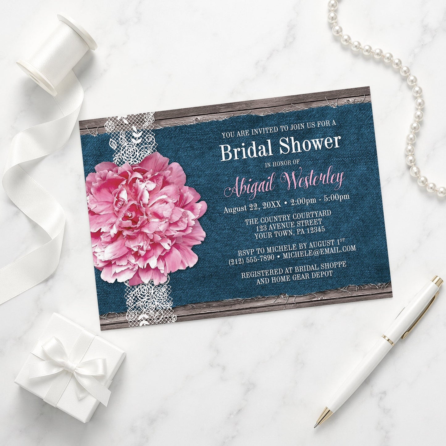 Pink Peony Denim and Lace Rustic Bridal Shower Invitation shown on a marble surface with a white gift box, pen, ribbon, and pearls.