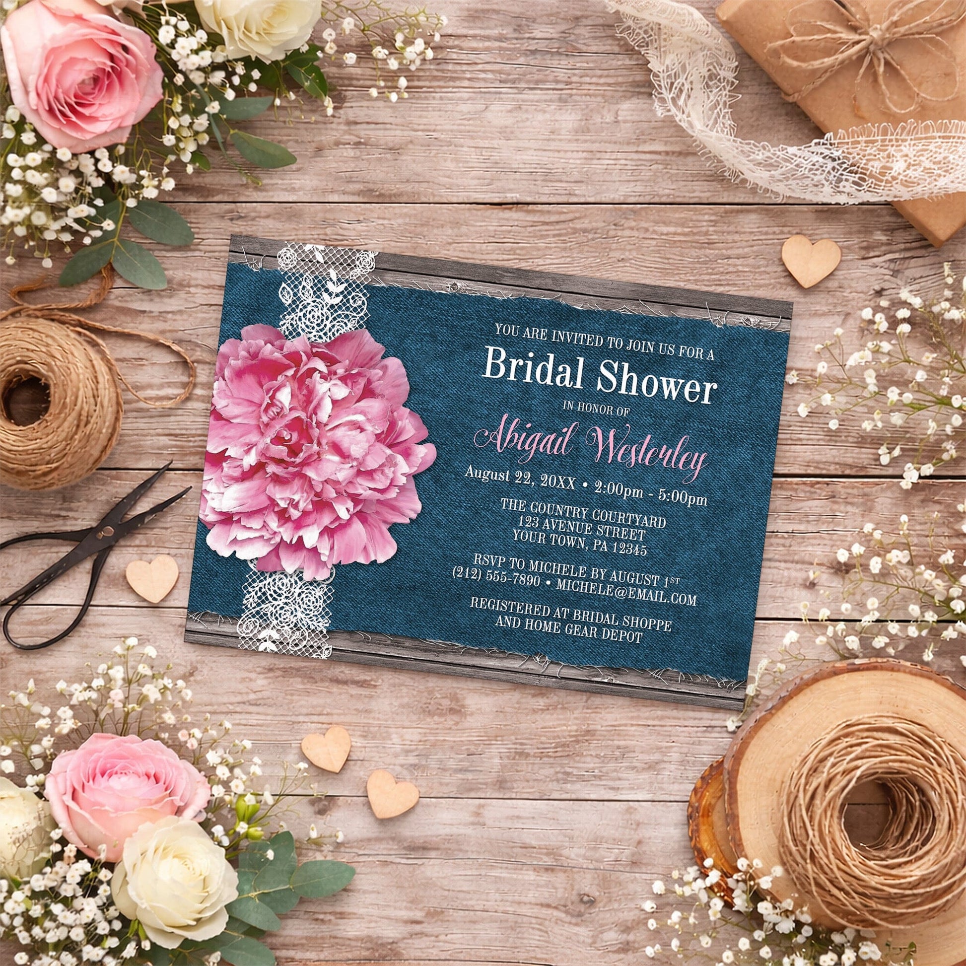 Pink Peony Denim and Lace Rustic Bridal Shower Invitation shown on a wooden surface with spring and summer flowers, small wood hearts, and ribbons.