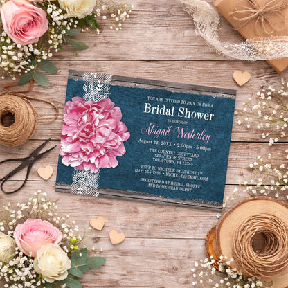 Pink Peony Denim and Lace Rustic Bridal Shower Invitation shown on a wooden surface with spring and summer flowers, small wood hearts, and ribbons.
