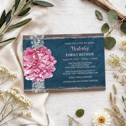 Pink Peony Denim and Lace Rustic Family Reunion Invitation shown on a wooden surface with spring and summer plants.