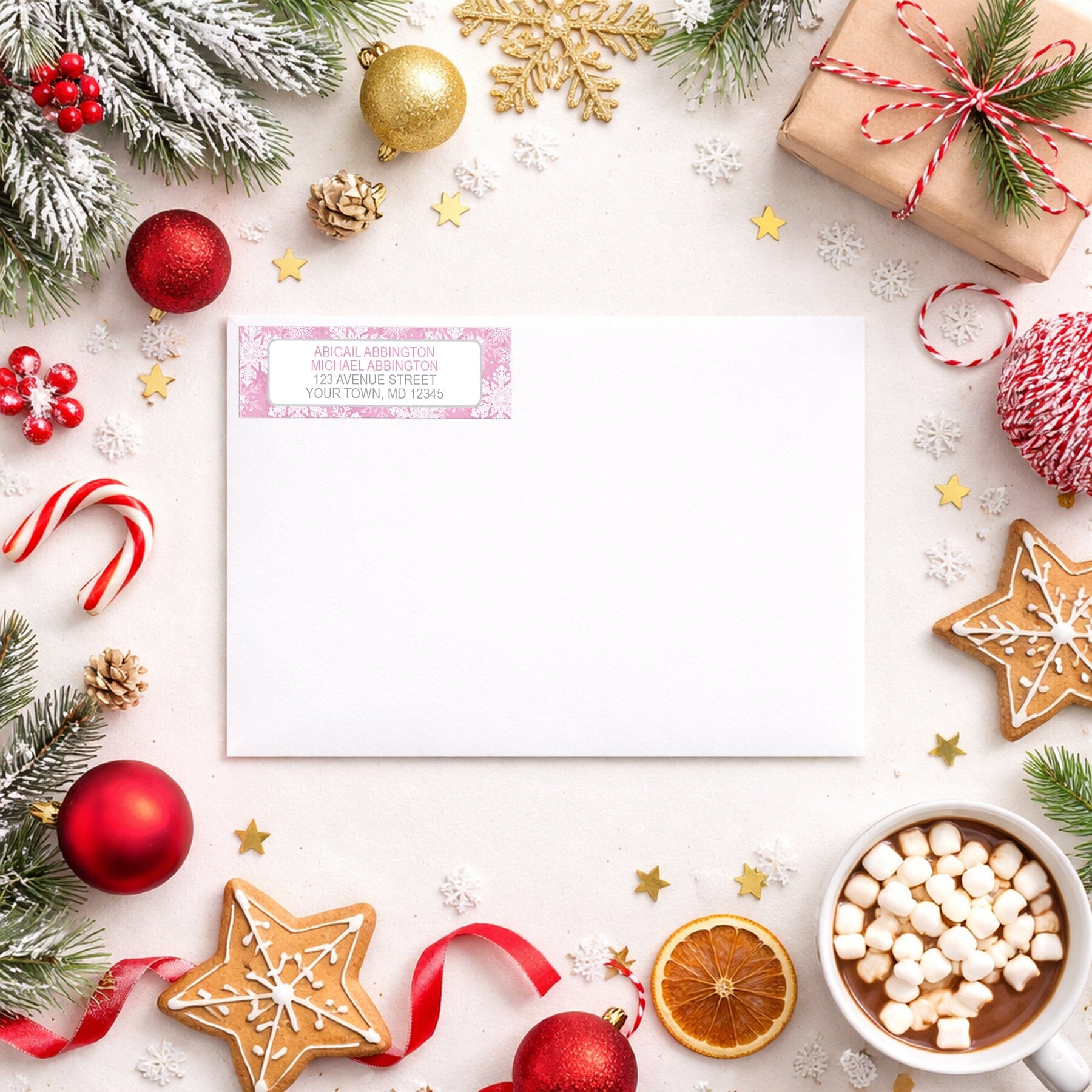 Pink Snowflake Winter Return Address Label shown on a white envelope with winter Christmas holiday supplies