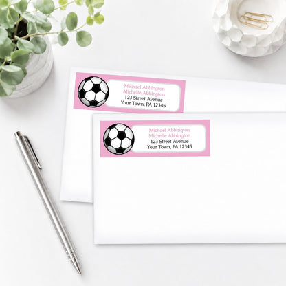 Pink Soccer Ball Address Labels on white envelopes, shown on a white surface with a plant and a pen.
