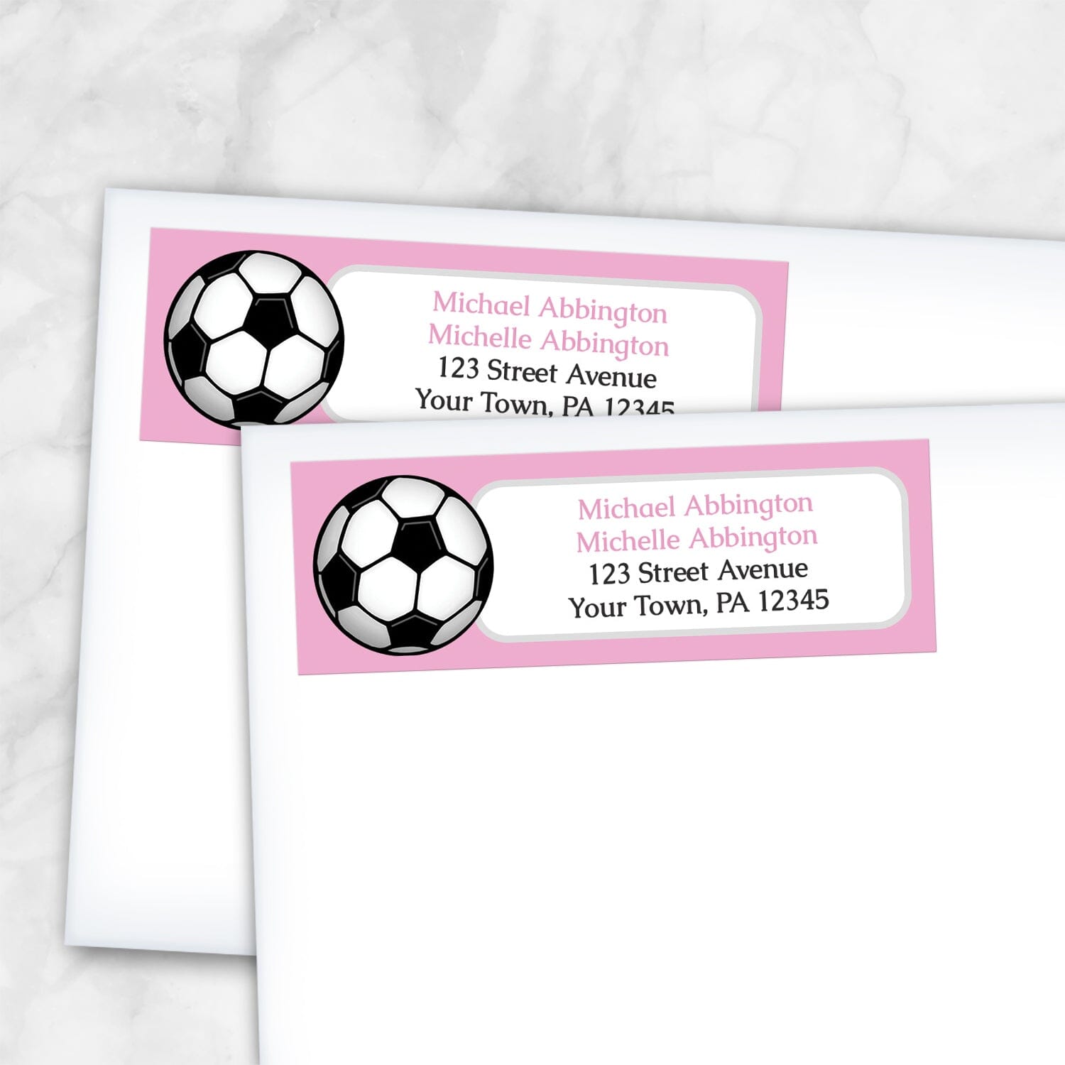 2 Pink Soccer Ball Return Address Labels shown on white envelopes on a marble surface