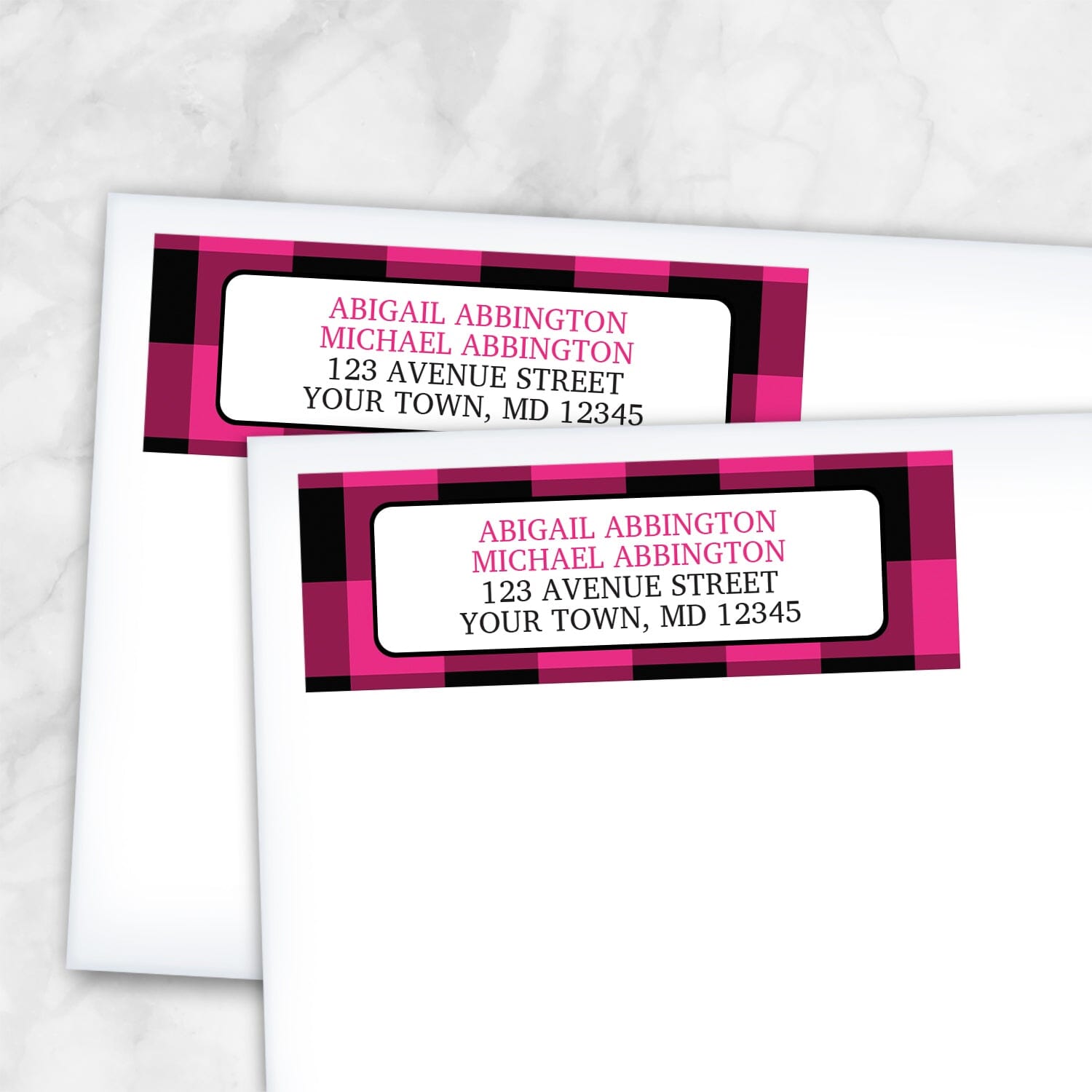 2 Pink and Black Buffalo Plaid Address Labels shown on white envelopes on a marble surface