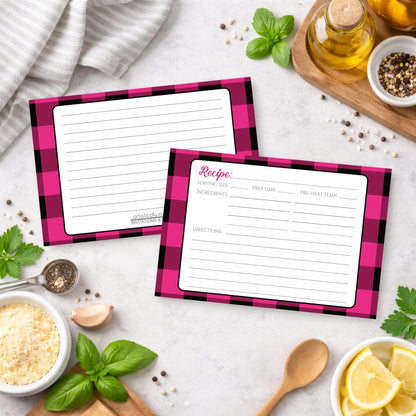 Two Pink and Black Buffalo Plaid Recipe Cards on a kitchen counter with ingredients.