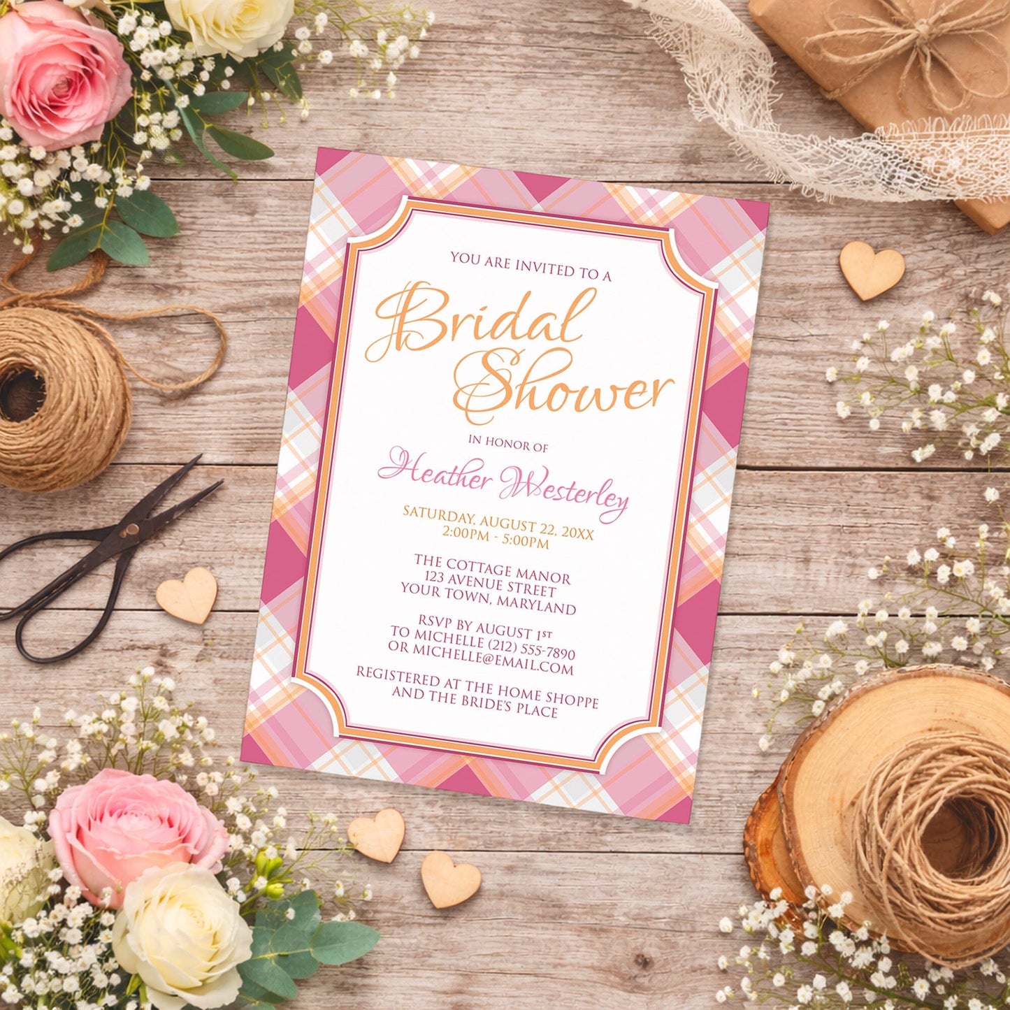 Pink and Orange Plaid Bridal Shower Invitation shown on a country-style wooden surface with spring and summer flowers, small wood hearts, lace ribbon, and twine.