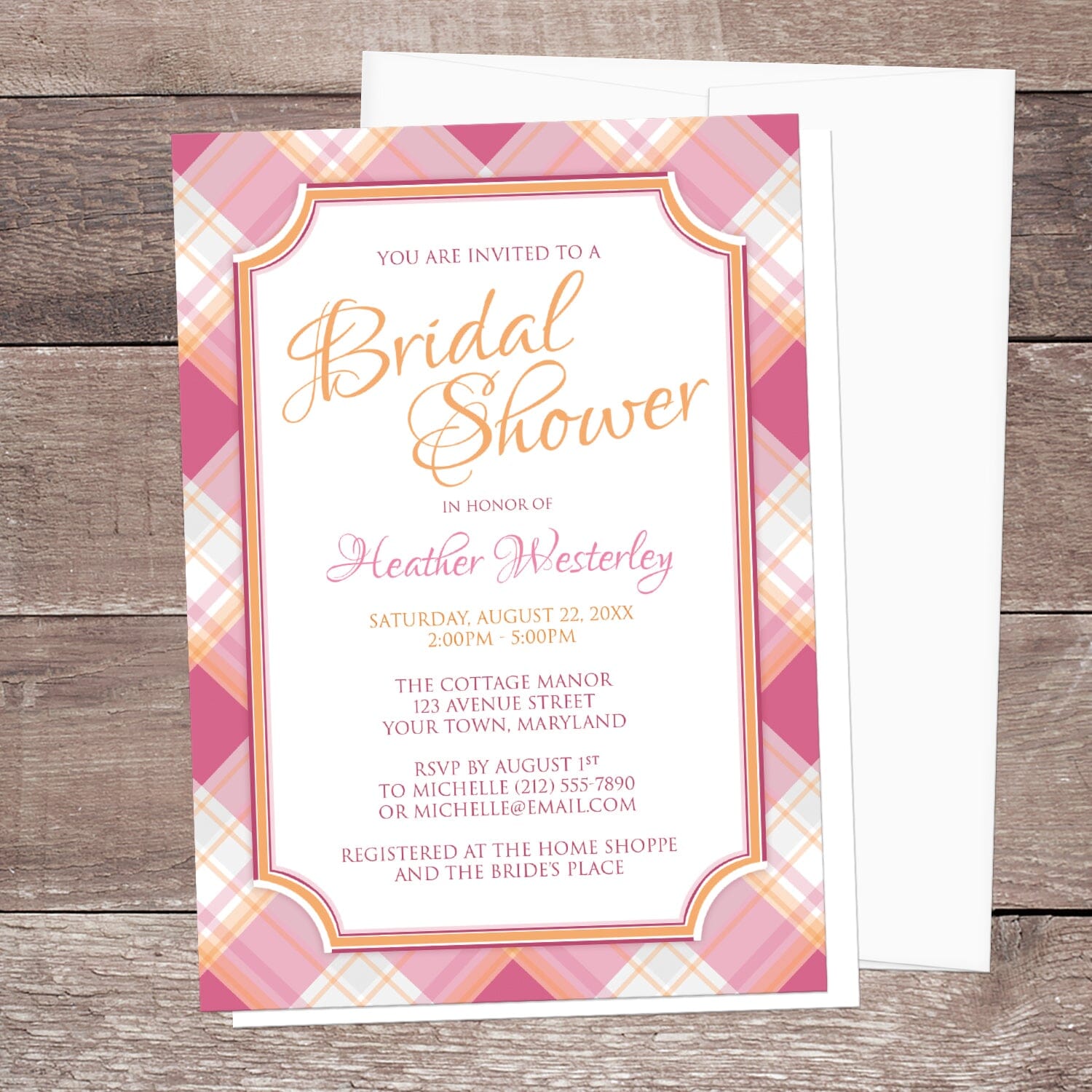 Pink and Orange Plaid Bridal Shower Invitation shown on a wood surface with a white envelope.