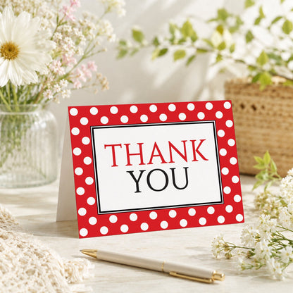 Polka Dot Red Black and White Thank You Card shown on a tabletop with a vase, spring and summer flowers, and a pen.