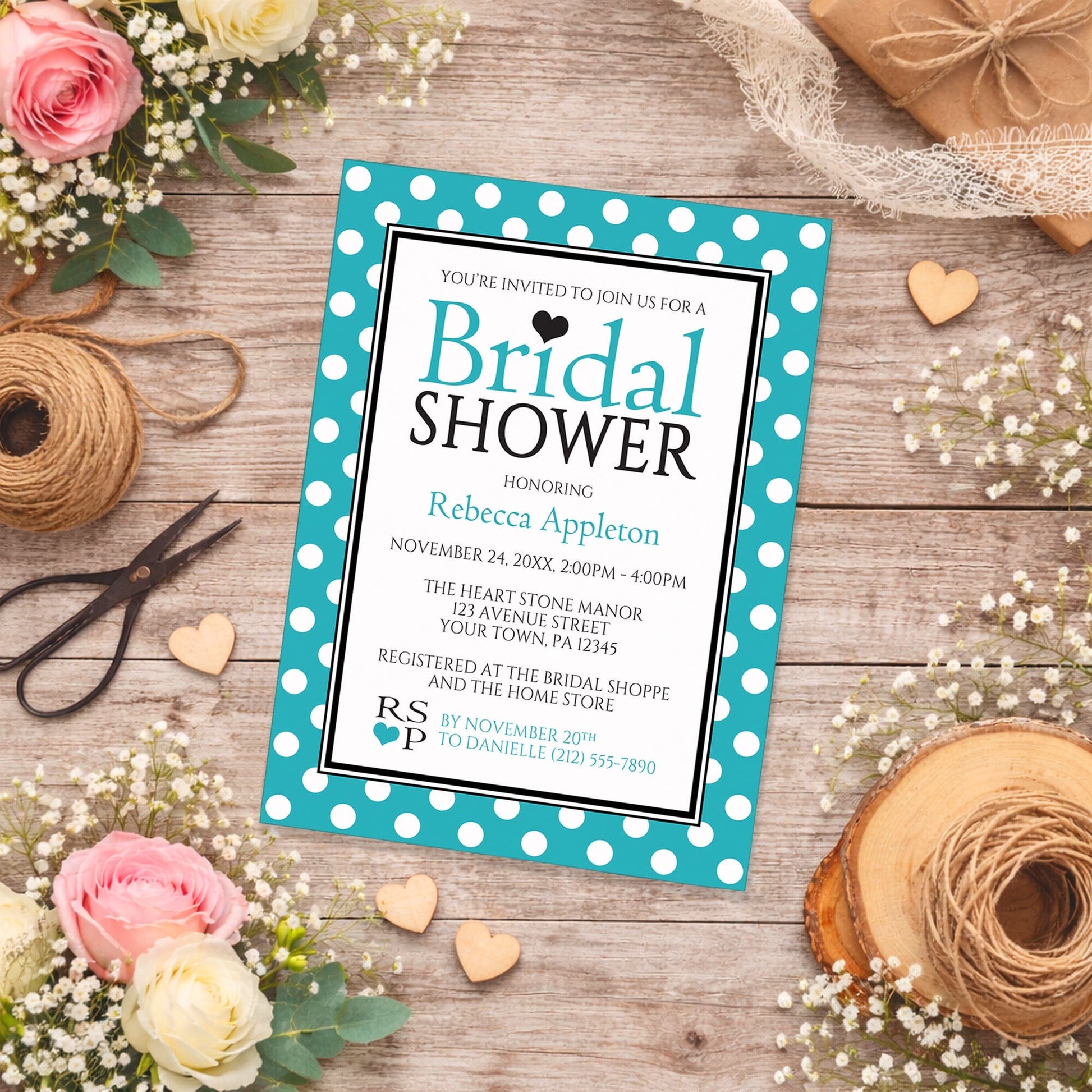 Polka Dot Turquoise Black and White Bridal Shower Invitation shown on a rustic wooden surface with spring and summer flowers, small wood hearts, and twine.