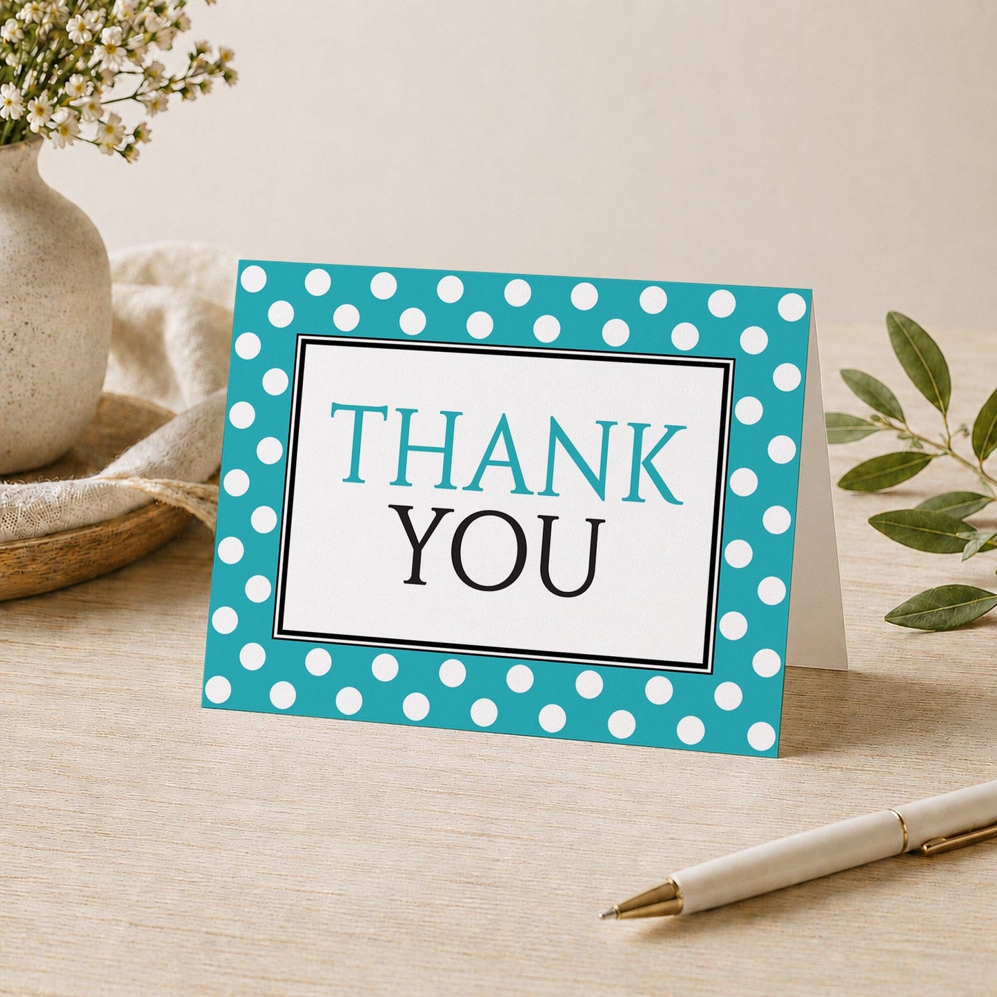 Polka Dot Turquoise Black and White Thank You Card shown on a desk with a vase, plants, and a pen.