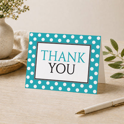 Polka Dot Turquoise Black and White Thank You Card shown on a desk with a vase, plants, and a pen.