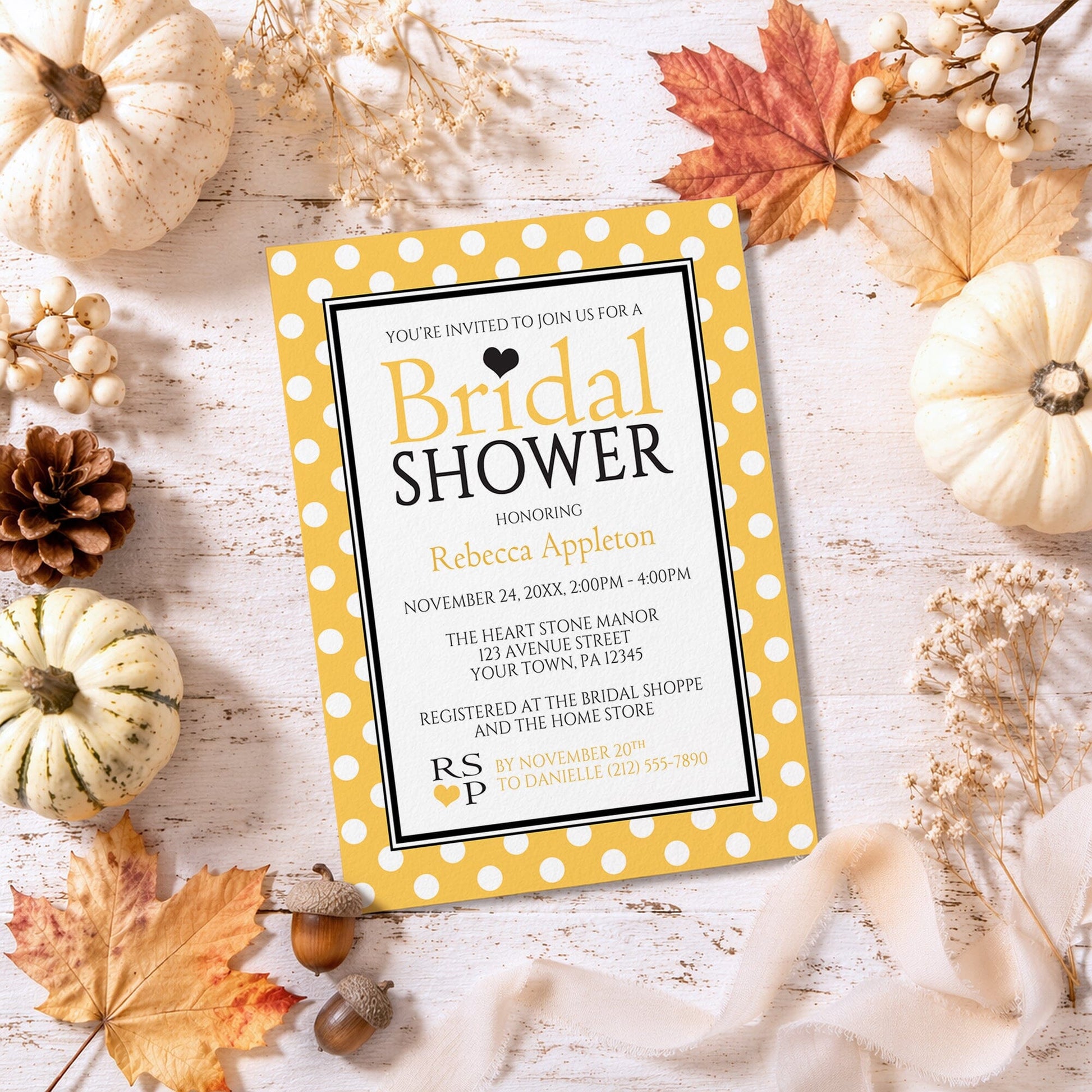 Polka Dot Yellow Black and White Bridal Shower Invitation shown on a rustic background with fall leaves and autumn decor.