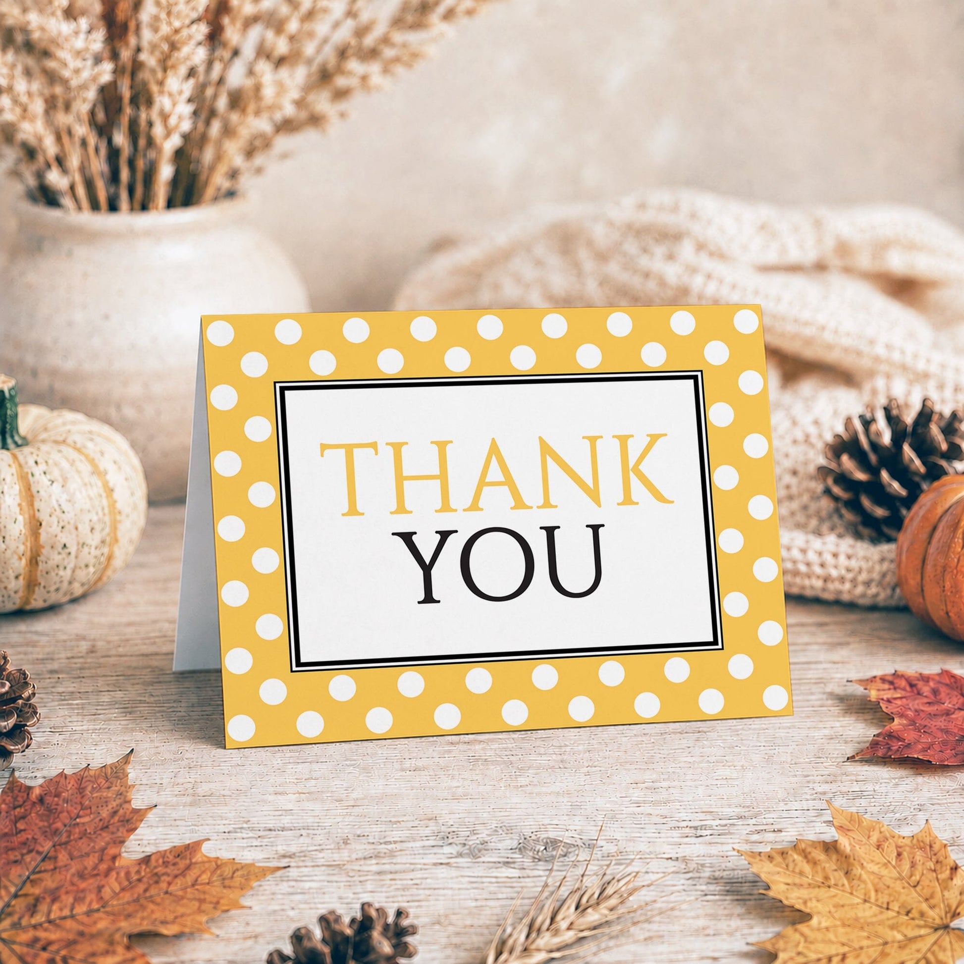 Polka Dot Yellow Black and White Thank You Card shown on a tabletop with fall leaves and autumn decor.