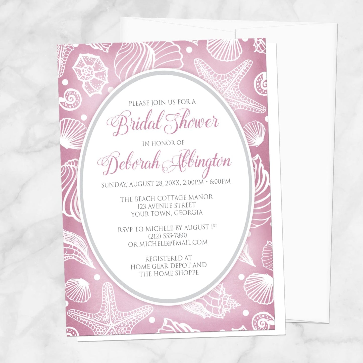 Pretty Pink Beach Seashell Bridal Shower Invitation shown on a marble surface with a white envelope.