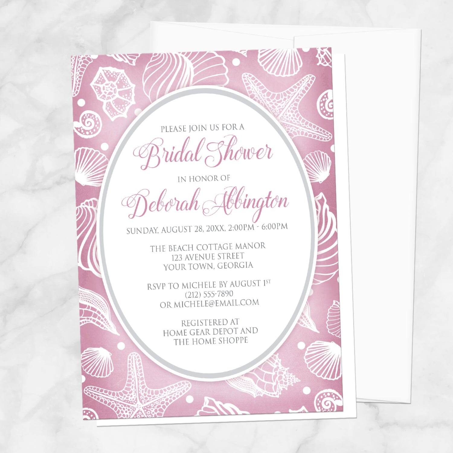 Pretty Pink Beach Seashell Bridal Shower Invitation shown on a marble surface with a white envelope.
