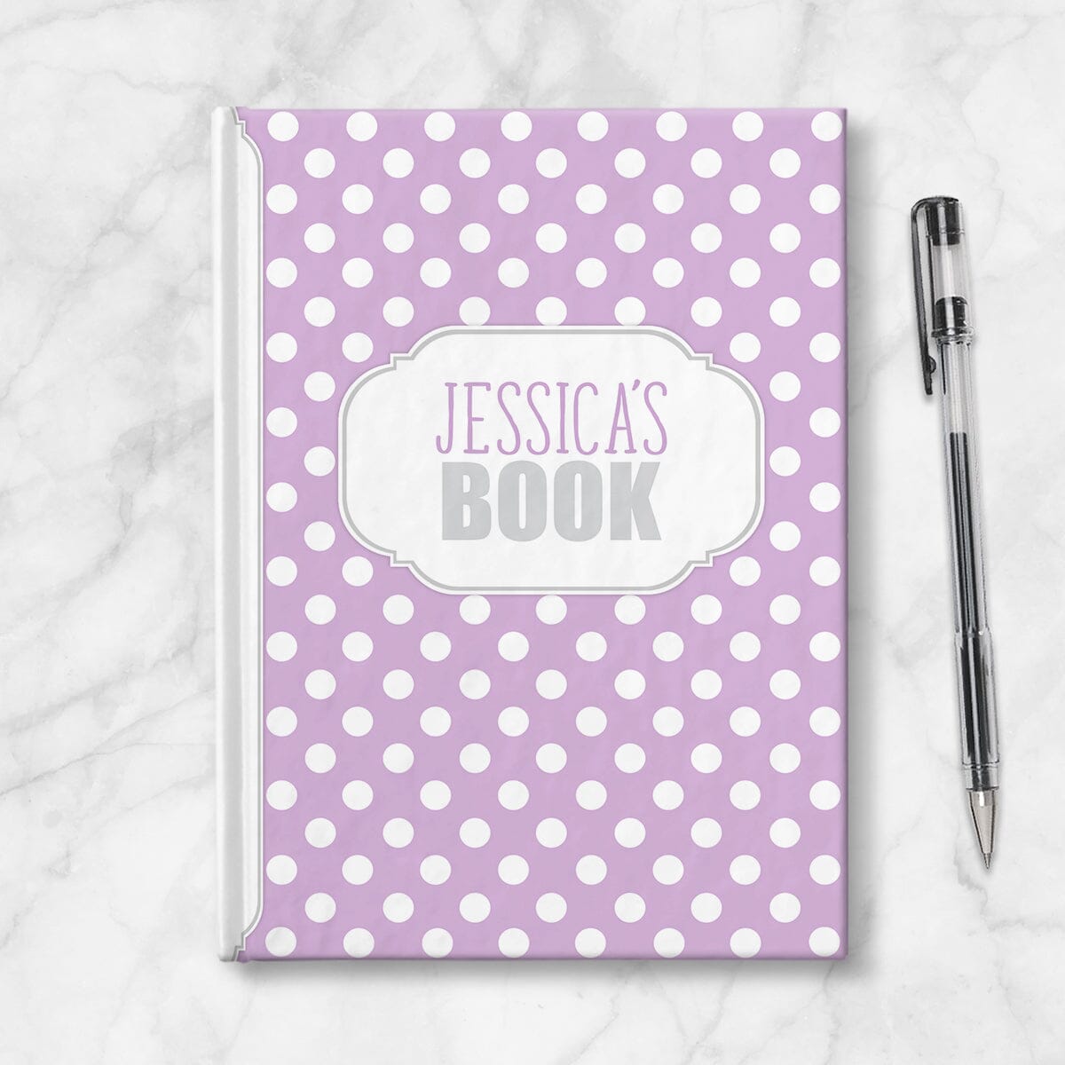 Personalized Purple Polka Dot Journal at Artistically Invited. Image shows the book on a countertop next to a pen.