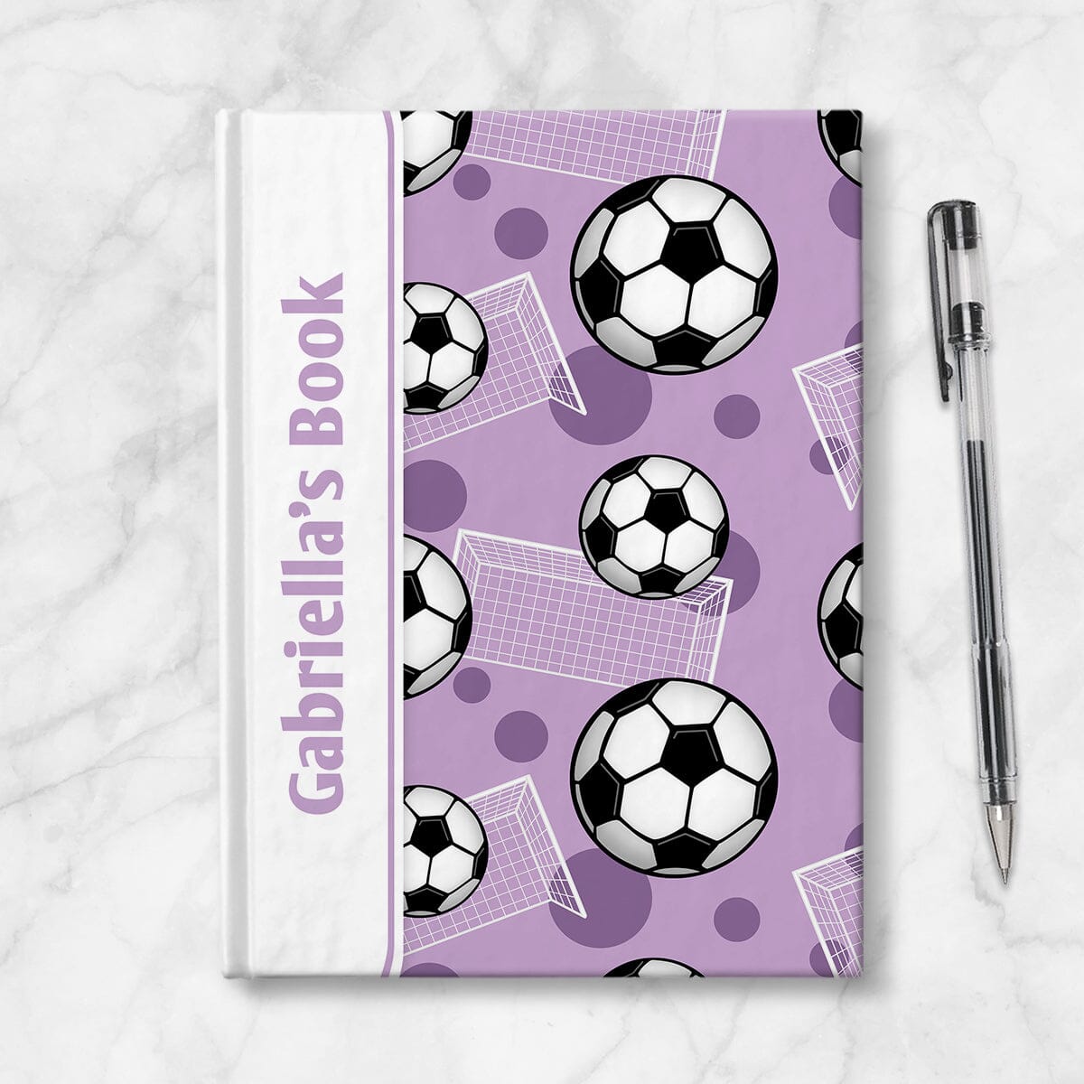 Personalized Purple Soccer Journal at Artistically Invited. Image shows the book on a countertop next to a pen.