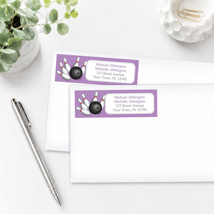 Purple Bowling Address Labels on white envelopes, shown on a white surface with a plant and a pen.