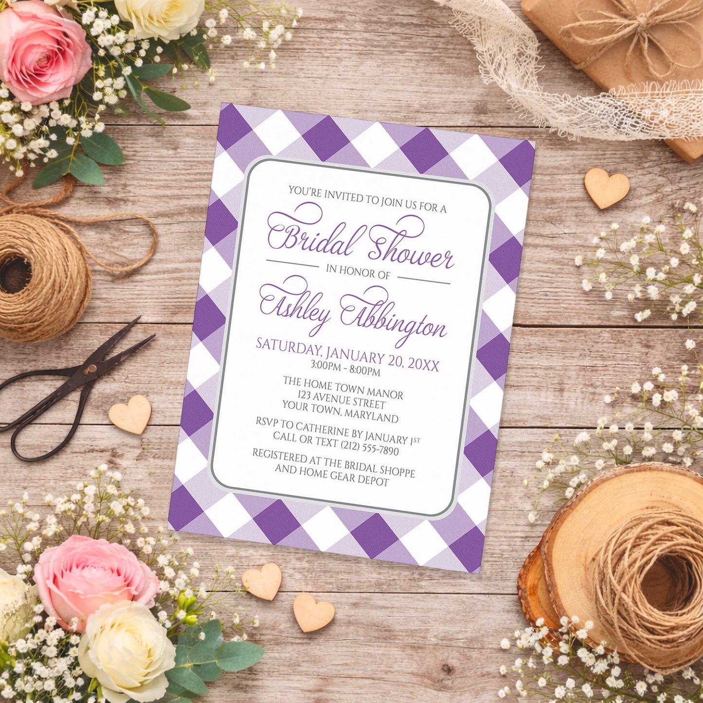 Purple Gingham Bridal Shower Invitation on a rustic wood surface with flowers and twine.