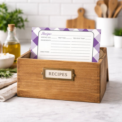 Wooden recipe box with a Purple Gingham Recipe Card inside on a kitchen counter