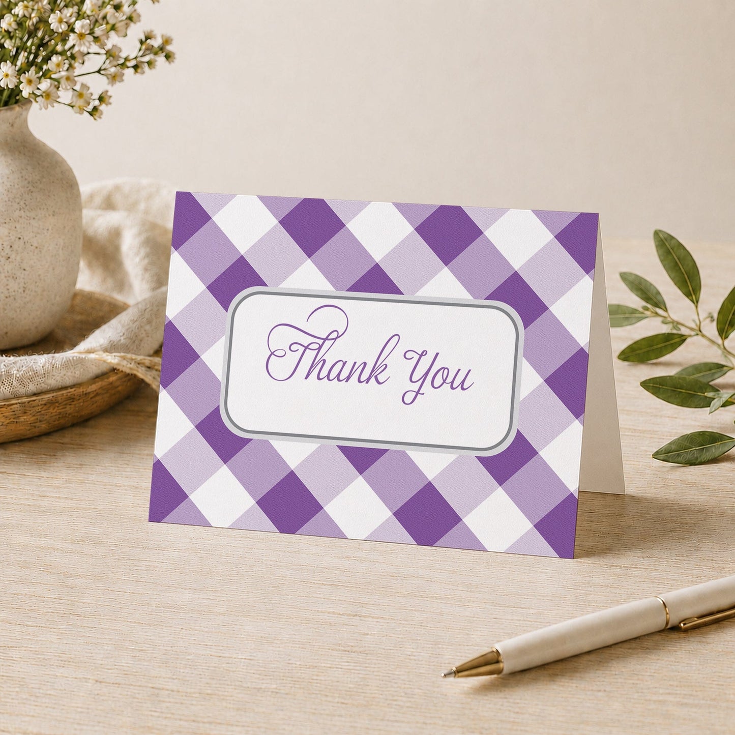 Purple Gingham Thank You Card shown on a desk with a vase, plants, and a pen.