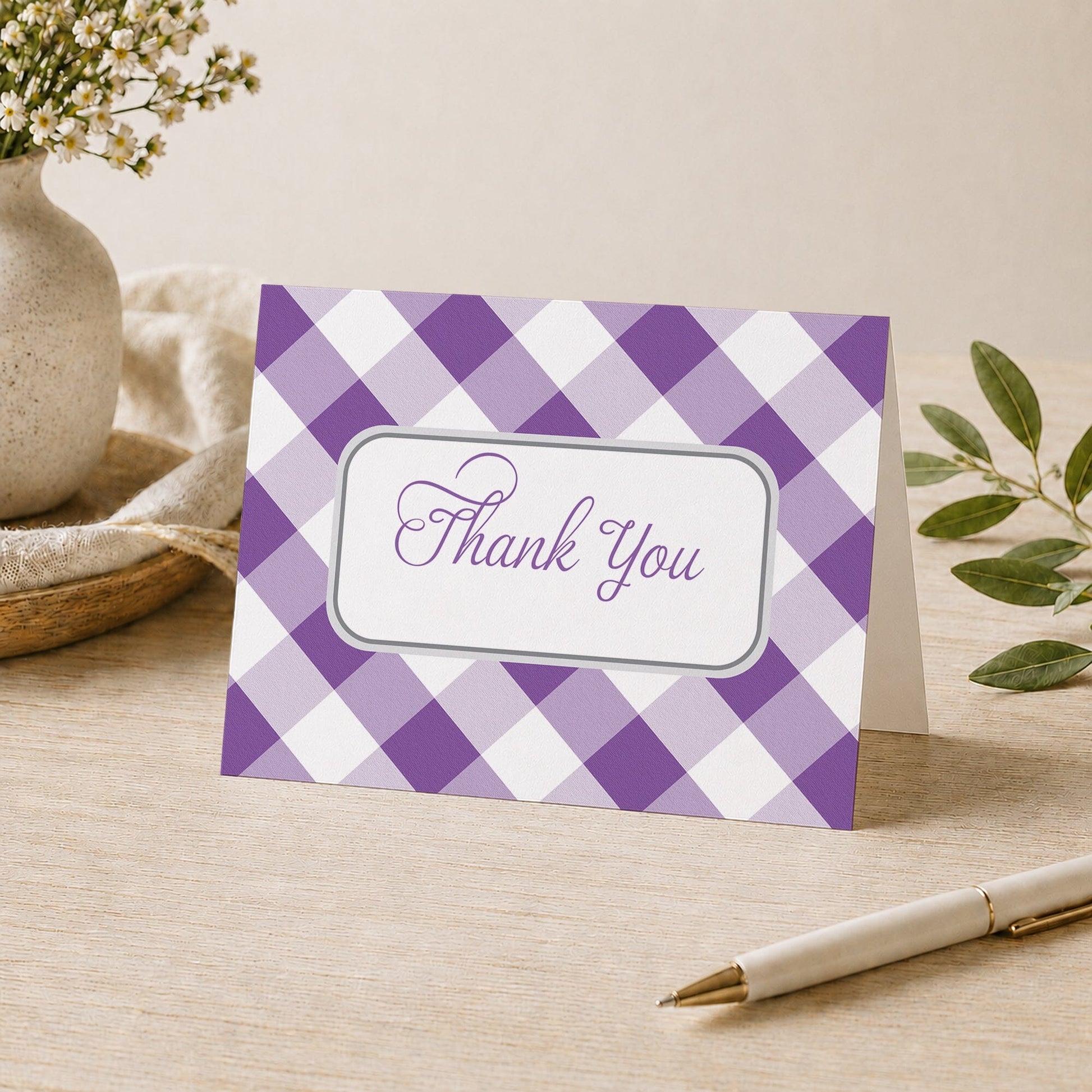 Purple Gingham Thank You Card shown on a desk with a vase, plants, and a pen.