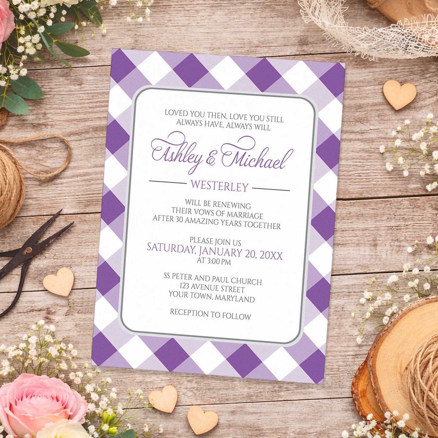 Purple Gingham Vow Renewal Invitation shown on a wooden surface with spring and summer flowers, small wood hearts, lace, and twine.