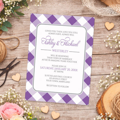 Purple Gingham Vow Renewal Invitation shown on a wooden surface with spring and summer flowers, small wood hearts, lace, and twine.
