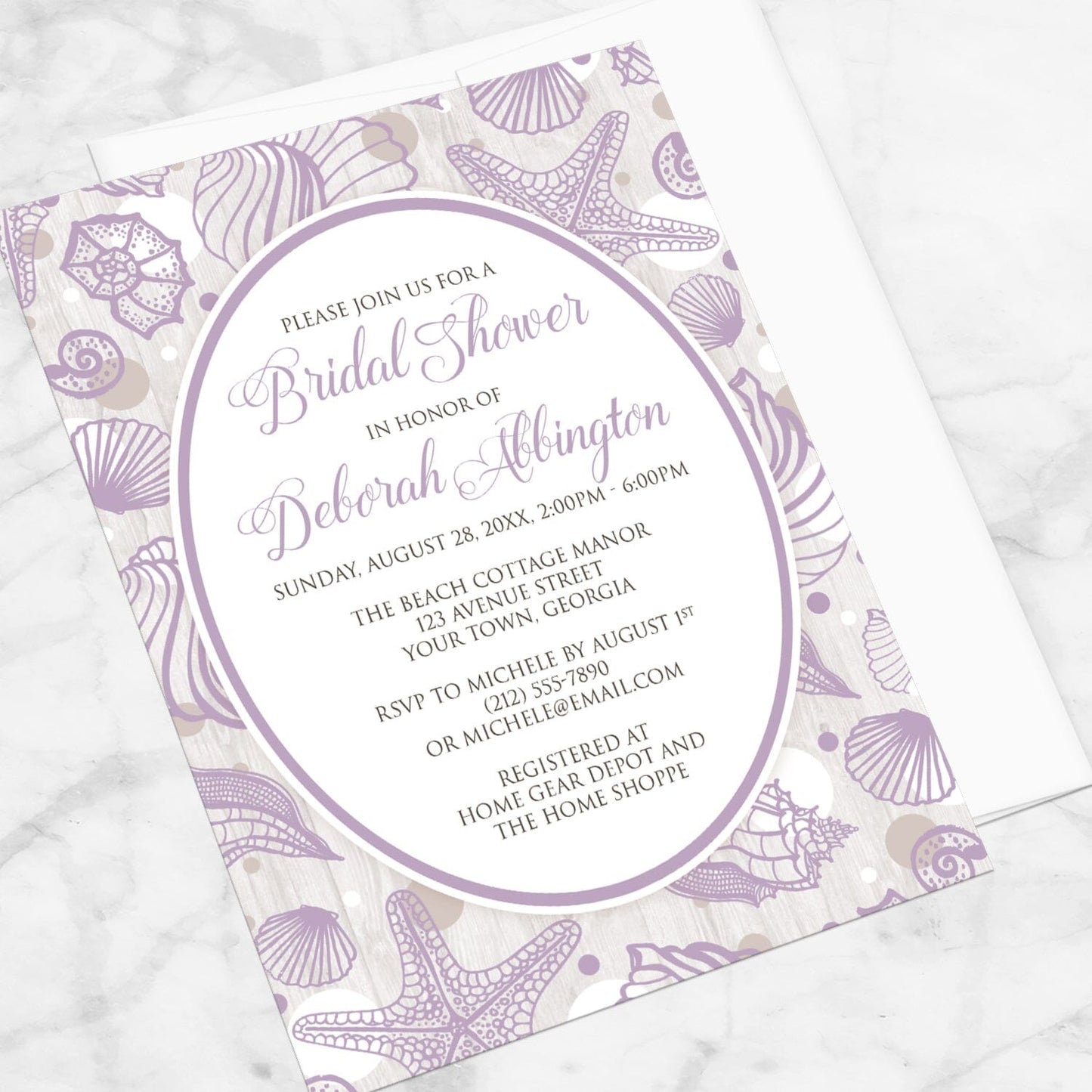 Purple Seashell Whitewashed Wood Beach Bridal Shower Invitation shown at an angle on a marble surface with a white envelope.