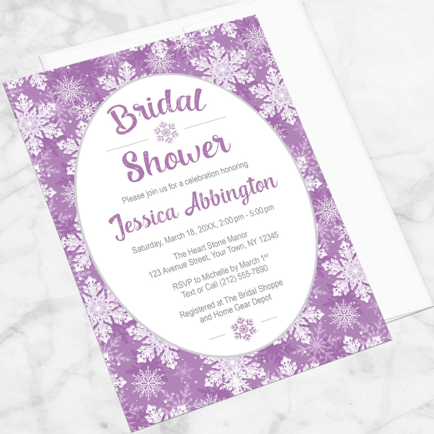 Purple Snowflake Bridal Shower Invitation shown at an angle on a marble surface with a white envelope.