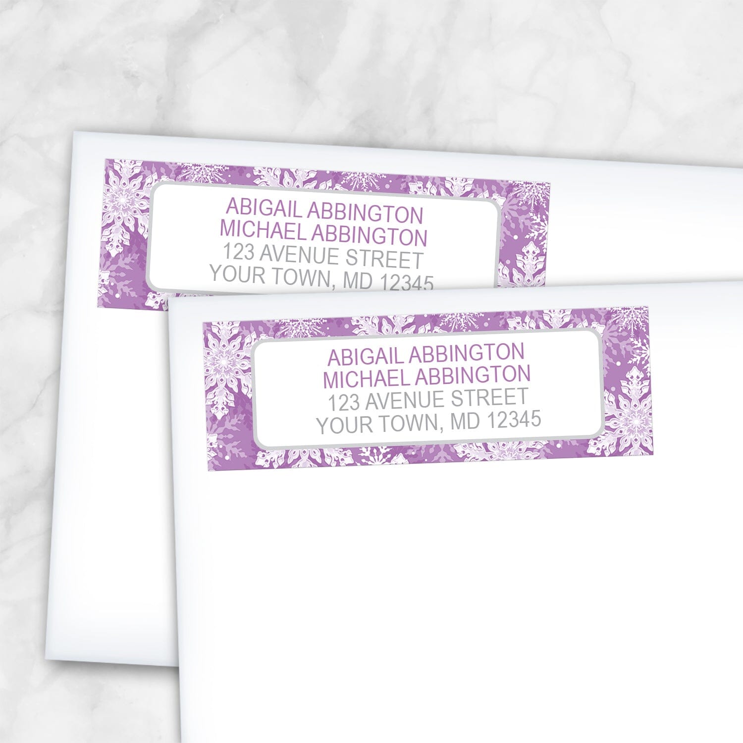 2 Purple Snowflake Winter Return Address Labels shown on white envelopes on a marble surface