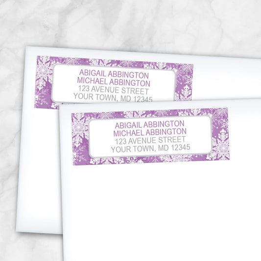 2 Purple Snowflake Winter Return Address Labels shown on white envelopes on a marble surface