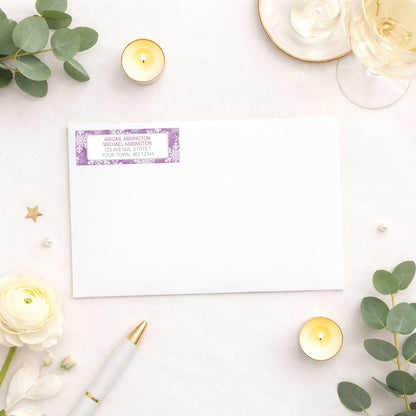 Purple Snowflake Winter Return Address Label shown on a white envelope with wedding and shower supplies
