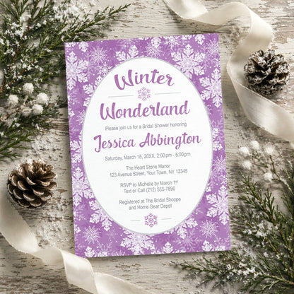 Purple Snowflake Winter Wonderland Bridal Shower Invitation shown on a rustic painted wooden surface with winter greenery, pine cones, and ribbons.