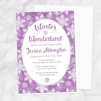 Purple Snowflake Winter Wonderland Bridal Shower Invitation shown on a marble surface with a white envelope.