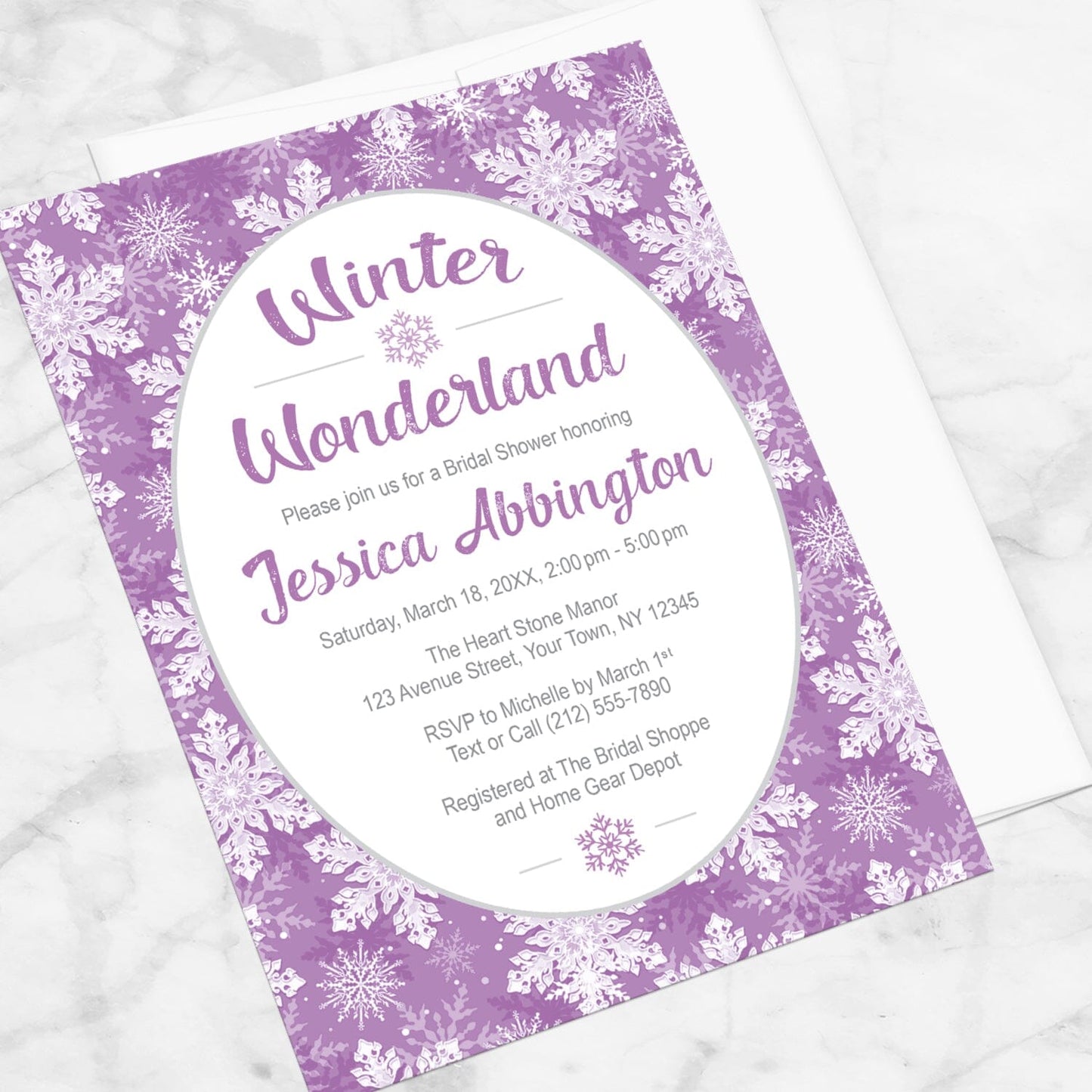 Purple Snowflake Winter Wonderland Bridal Shower Invitation shown at an angle on a marble surface with a white envelope.